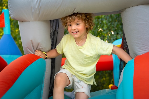 Kid playing in bounce house side view