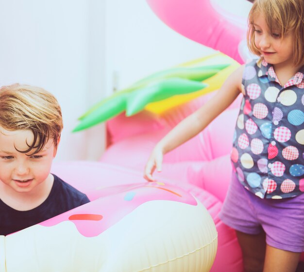 Kid playing colorful life ring together