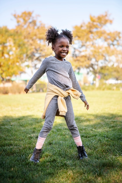 Free photo kid playing outdoorns in the park