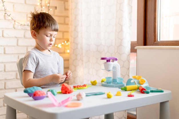 Free photo kid playing at table