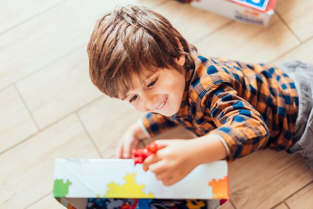 Kid playing with jigsaw