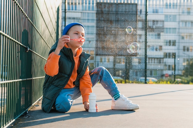 Kid playing with soap bubbles