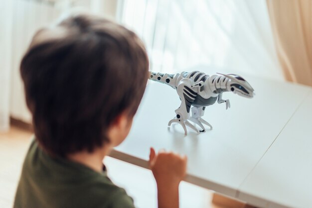 Kid playing with toy dinosaurs