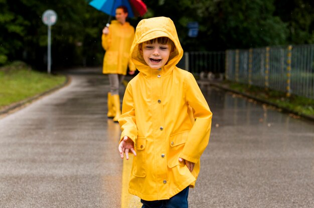 Kid in rain coat smiling