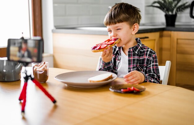 Kid recording himself while eating