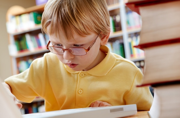  kid using laptop on desk
