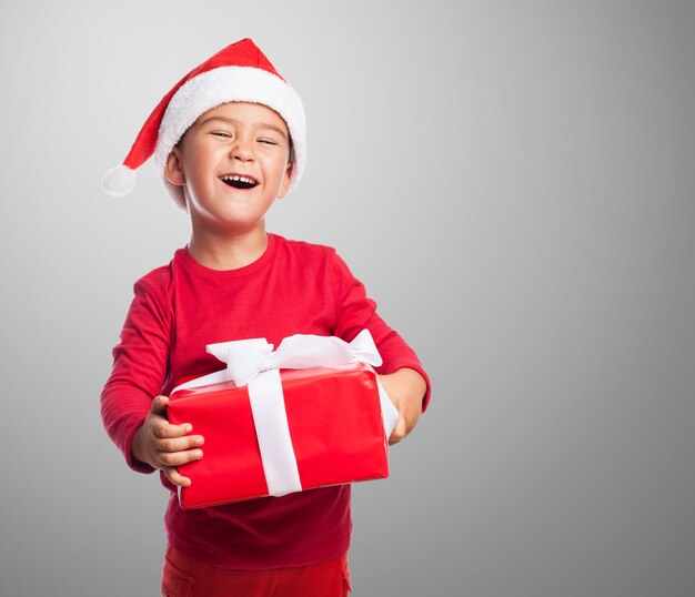 Kid with a funny face holding a present