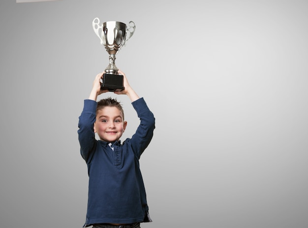 Kid with a trophy on his head