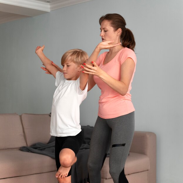 Kid and woman meditating medium shot