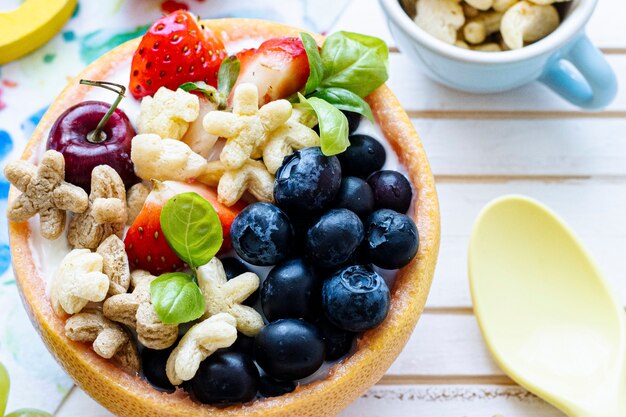 Kids cereal bowl treat with berries and yogurt