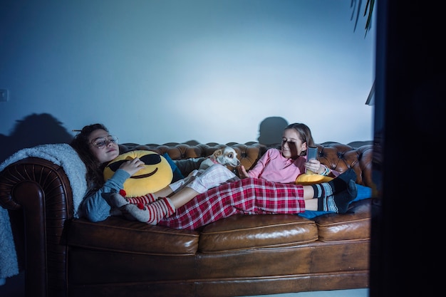 Free photo kids chilling on sofa with dog