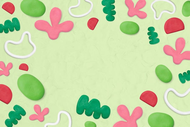 Free photo kids clay patterned frame on green textured background creative craft for kids