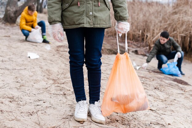 Kids cleaning the ground and recycling