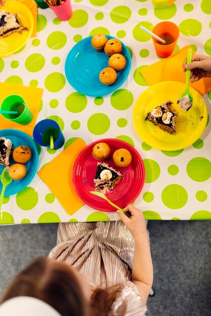 Kids eating cakes from above