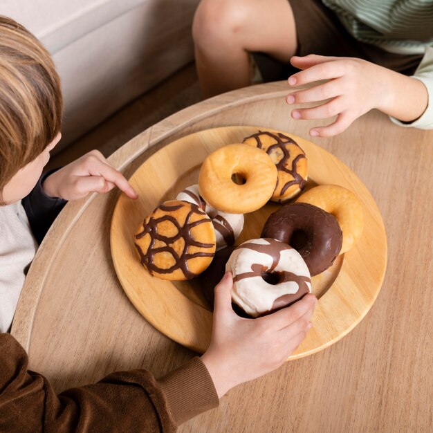 Kids eating doughnuts at home