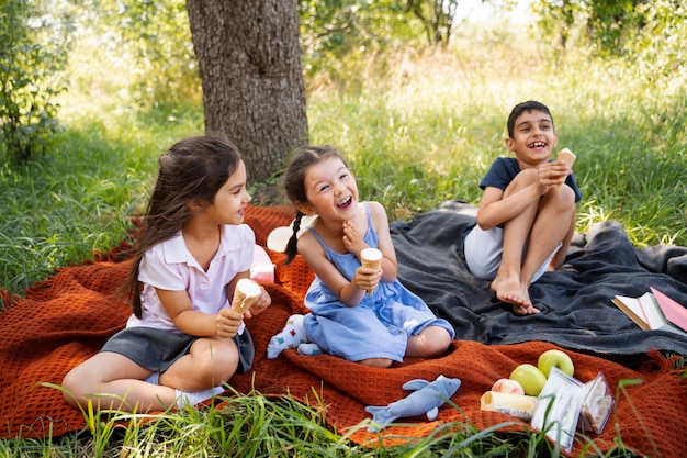 Kids eating ice cream together outdoors