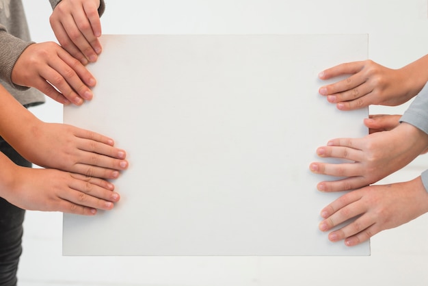 Free photo kids' hands holding paper