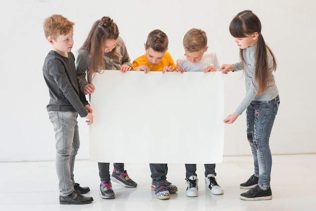 Free photo kids holding blank sign