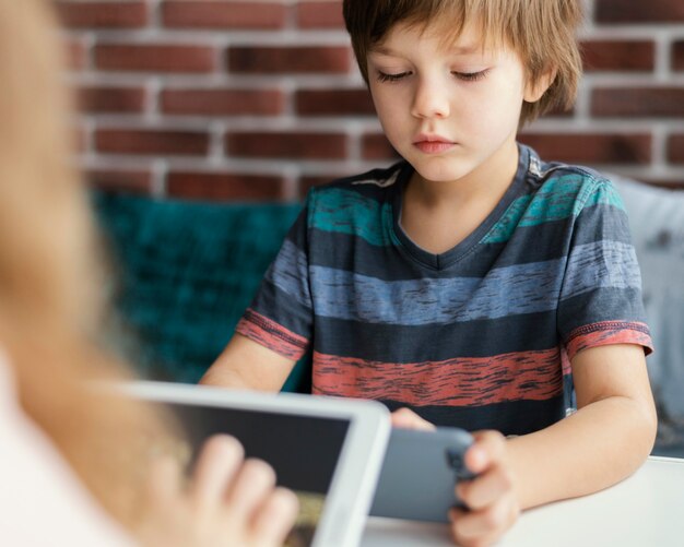 kids holding devices indoors