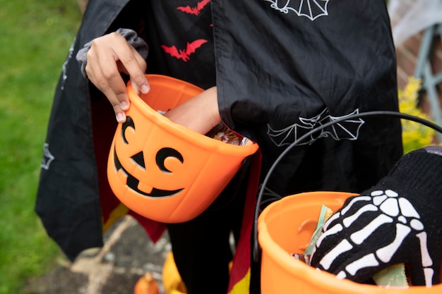 Free photo kids holding their trick or treat buckets