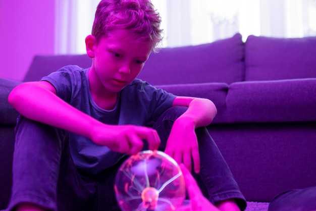 Free photo kids interacting with a plasma ball