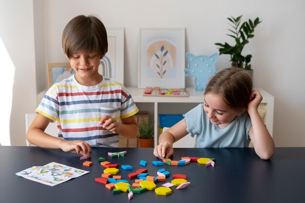 Kids making puzzle together front view