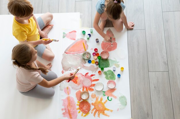 Kids painting together as team