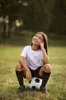 Free photo kids playing football supervised by football trainer