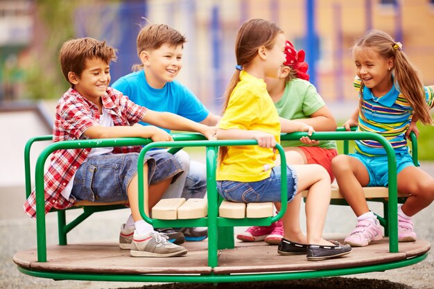 kids playing and laughing with the carousel