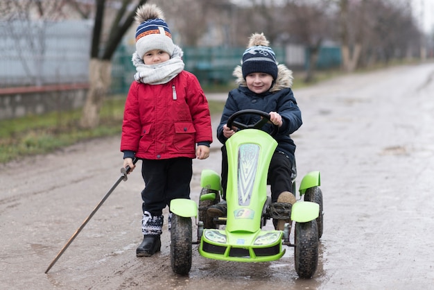 Kids playing outside with cart