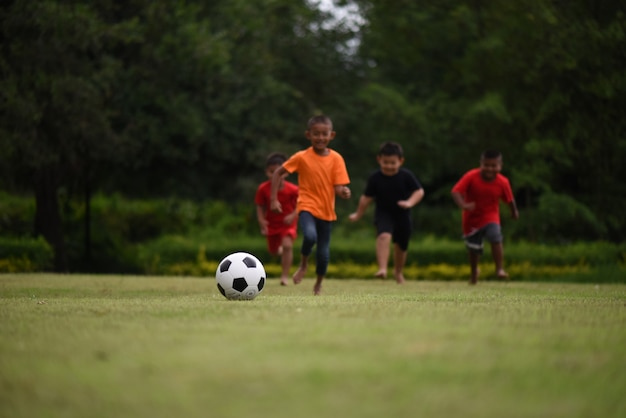 Kids playing soccer football