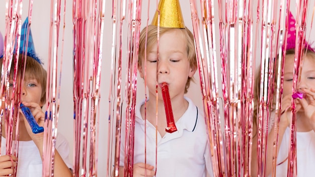 Kids playing with party whistles