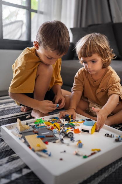 Kids playing with toys indoors full shot