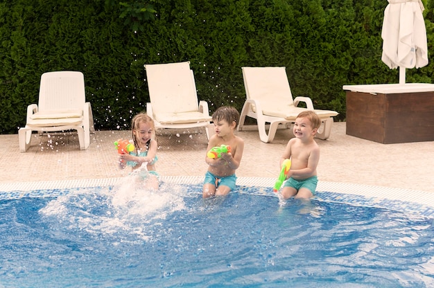 Free photo kids playing with water guns