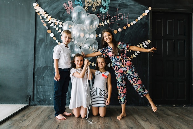 Kids posing with balloons on birthday party