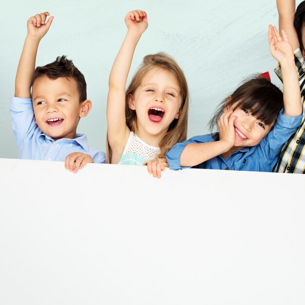 Kids raising arms cheering with mockup board