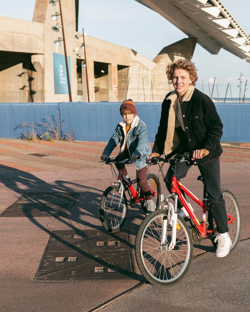 Free photo kids riding bicycles outdoors together