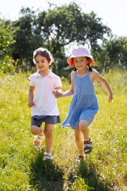 屋外の芝生で走ったり遊んだりする子供たち