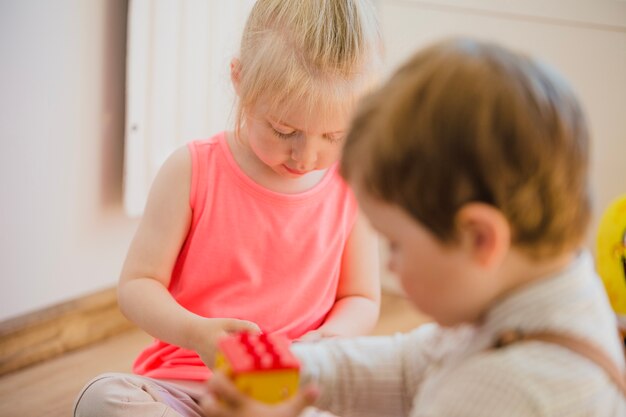 Kids sitting on floor playing