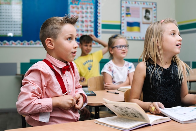 Kids sitting at lesson in classroom