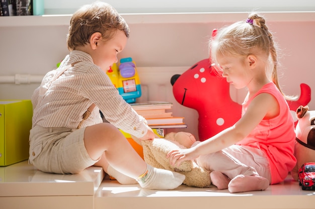 Kids sitting playing with fluffy toy