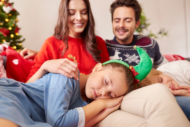 Kids sleeping on the knee of parents