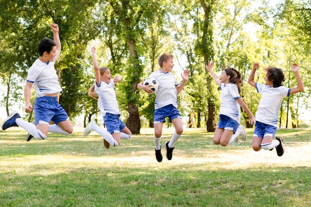 Kids in sportswear jumping outdoors