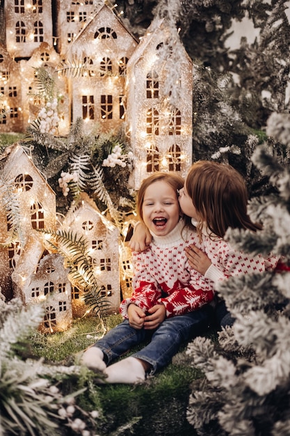 Kids standing on the upper level of Christmas decoration