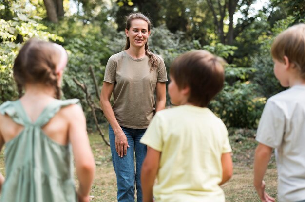 Kids and teacher outdoors lesson