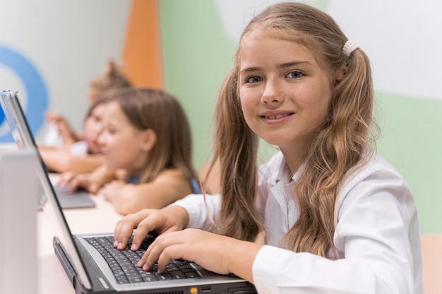 Kids using laptop at school