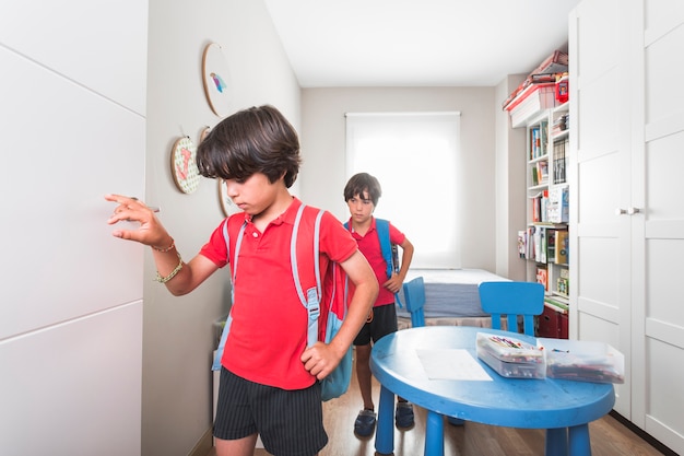 Kids walking in room with backpacks