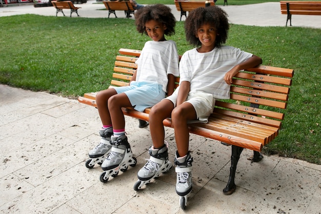 Free photo kids wearing roller skates full shot