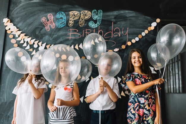 Kids with balloons on birthday party