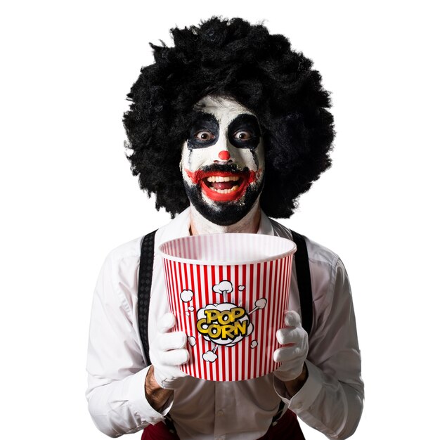 Killer clown eating popcorns